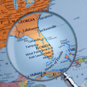 Map of florida with magnifying glass over state. Discover Tax Relief Services in Stuart - Serving All 50 States!